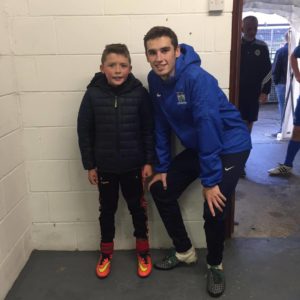 Match Day Mascot Eoin Cunningham with NCAFC Player Mark McCabe.