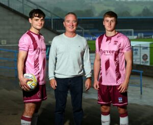 NCAFC first team players Lorcan Forde and Charlie McGrath in the new Evora Cup kit with Damien Hillen Director of Development at Evora